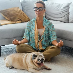 Poster One woman having relax at home with yoga routine lotus position in living room with her best friend dog laying near her. Concept of easy and healthy mental lifestyle people. Dog owner. Wellbeing lady © simona