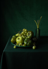Green fruits and vegetables on a green table 