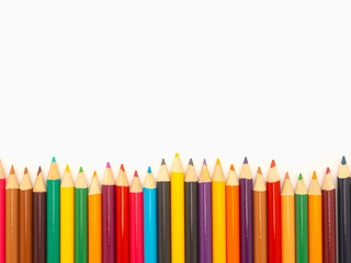 Colorful colored pencils on a white background in a creative workspace.