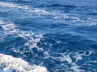 Fototapeta premium blue sea water with white foam from boat