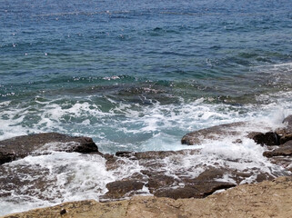 small sea waves splashing the rocks 