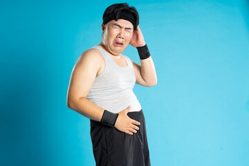 Image of Asian man exercising on blue background