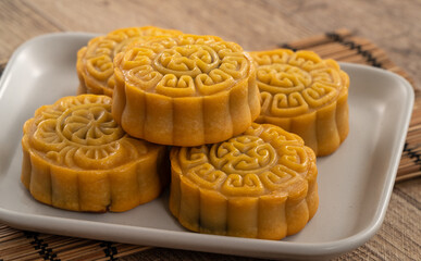 Delicious Cantonese moon cake for Mid-Autumn Festival food mooncake on wooden table background.