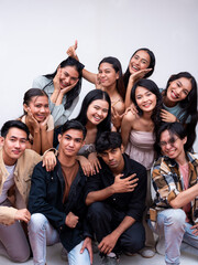 A diverse group of ten young asian college students posing together smiling. 5 women, 4 guys and 1 trans woman. Isolated on a white background.