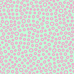 Seamless rings pattern. Pink hand-drawn oval isolated on a mint background. Doodle dots pastel ovate ornament. Vector dotted illustrations with circles for wallpaper, posters, wrapping paper, fabric