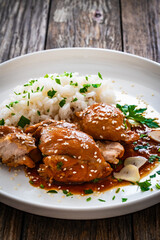 Hawaiian chicken style - shoyu chicken thighs with white rice on wooden table
