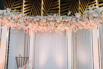 Decor in the banquet area. Wedding decorations in luxury ceremony. Festive arch, wall decorated...