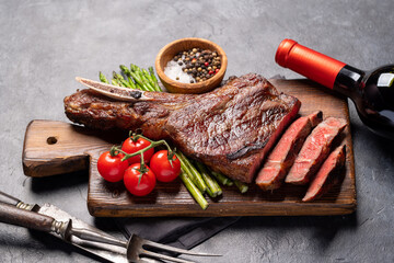 Medium rare grilled Tomahawk beef steak with asparagus