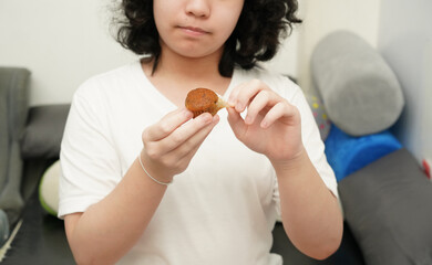 girl peeling muffin wrapper for eating ,close up