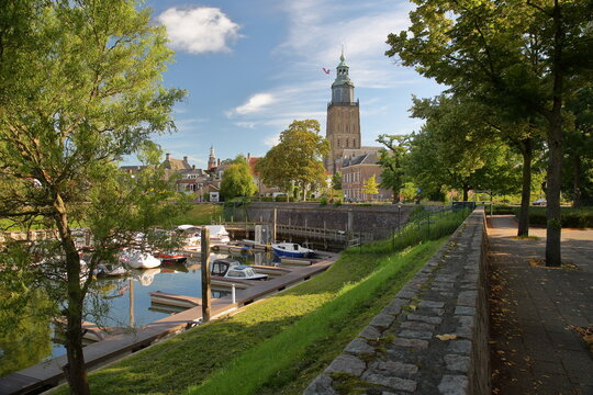 The harbor Vispoorthaven located along river IJssel in Zutphen, Gelderland, Netherlands, with the bell tower of Saint Walburgiskerk church and the tower Wijndragerstoren (or Wijnhuistoren) 