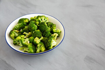 Homemade Pan-fried Broccoli on a Plate on a gray background, side view. Copy space.