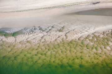 Aerial view from a plane above National Park and natural reserve “Wattenmeer“ (Waddensea) near...