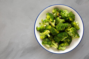 Homemade Pan-fried Broccoli on a Plate on a gray background, top view. Copy space.