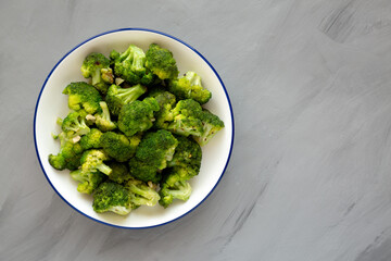 Homemade Pan-fried Broccoli on a Plate on a gray background, top view. Copy space.