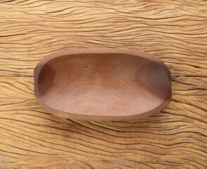Empty handmade wooden bowl over wooden table