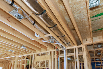 Installing central HVAC system puts spotlight on wooden beamed ceiling in new home.