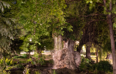 Nighttime long exposure photo of the Cismigiu Park fountain in Bucharest, Romania.
