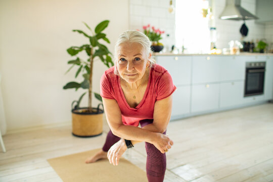 Senior woman working out at home