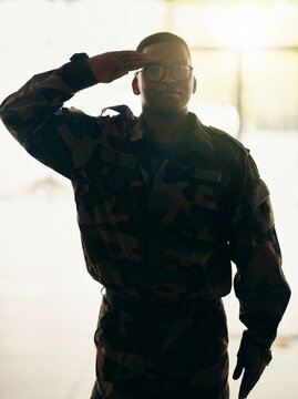 Confident soldier portrait, army and salute in building with pride, professional hero and night service. Military career, security and courage, black man in camouflage uniform at government agency.