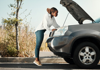 Mechanic, broken car and black woman in the road fixing her engine problem or emergency. Transportation, travel and young African female person checking her motor vehicle for accident in the street.