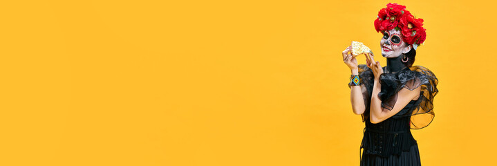 Banner. Young pretty woman in spooky makeup eating delicious hot pizza against bright yellow...