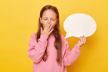 Space for promotional material. Promotion-ready space. little kid girl wearing pink sweatshirt isolated over yellow background holding empty speech bubble being sleeping yawning