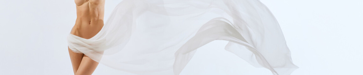 Banner. Cropped portrait. Body of young beautiful naked woman through transparent fabric on light background. Ad.