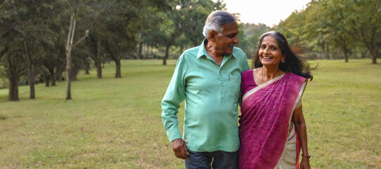 Loving Senior Indian Couple Enjoying a Walk in the Park. Retirement Goals for an Older Couple.
