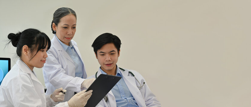 A team of professional Asian scientists or researchers have a medical research meeting in the laboratory with space for advertisement or text - Powered by Adobe