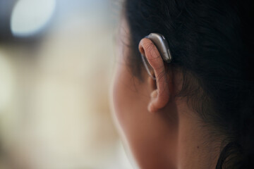 Hearing aid, closeup and ear with a person with a disability for helping with audio and medical...