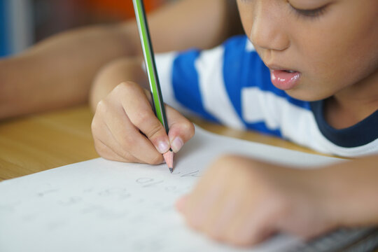 Boys Practice Writing Numbers And Letters.