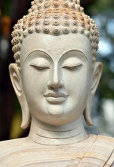 The face of a white stone Buddha