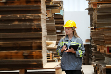 Warehouse workers checking the inventory. Products on inventory shelves storage. Worker Doing Inventory in Warehouse. Dispatcher in uniform making inventory in storehouse. supply chain concept	
