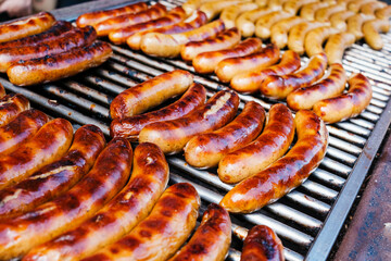 Grilled German sausages, golden on the fire.