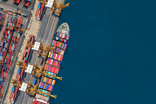 Industrial import-export port prepare to load containers. Aerial top view container ship in export and import global business and logistic. Global transportation and logistic business.