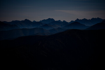 Dark silhouettes of the Tatra Mountains from the Mount Brestova.
