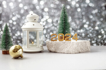 lantern with a lit candle, the numbers 2024 on a podium made of stone, Christmas balls and fir...