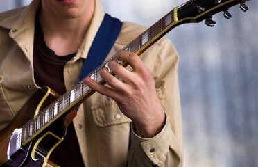 a musician plays an electric guitar on a stage