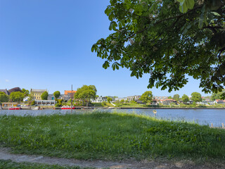 Happy walking in old Fredrikstad on a great warm summer day, with many old buildings, Norway