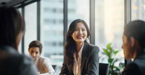 Asian female CEO with long hairs confidently leading a diverse boardroom meeting in office, symbolizing the increasing presence of women in top executive positions, copy space on right