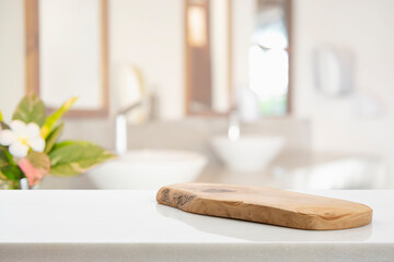 Wooden pedestal on table in bathroom interior and free space