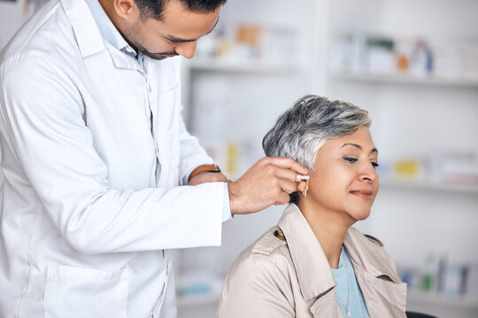 Hearing aid, medical and consulting with doctor and woman with a disability for healthcare, technology and sound waves. Medicine, wellness and audio with people and cochlear implant for treatment