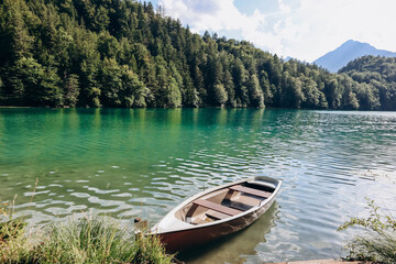 Naklejka na ściany i meble Lonely boat on the shore of Alat See lake in Bavaria, Germany