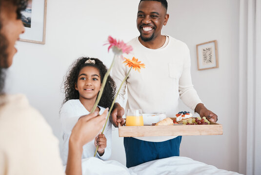 Mothers day, breakfast and mom in bed with happy family with dad and child together in home with love, care and brunch tray. Surprise, father and girl with food in bedroom for special celebration