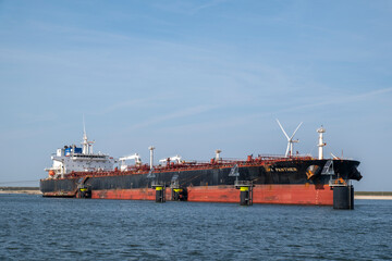 Large LNG tanker ship in a harbour on a clear summer day. Port of Rotterdam, the Netherlands