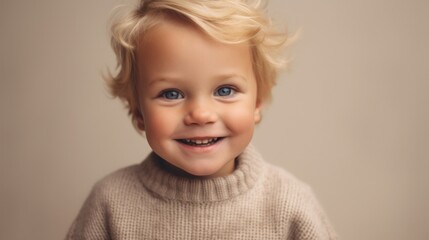 A cheerful blond toddler boy in neutral clothing, posing against a soft beige studio background, with an infectious smile aimed at the camera. Generative AI