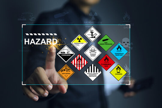 Hazardous substance concept engineer pointing on hazard icon dangerous goods store in warehouse create warning sign for different chemical separate storage area for cargo shipping and transportation.