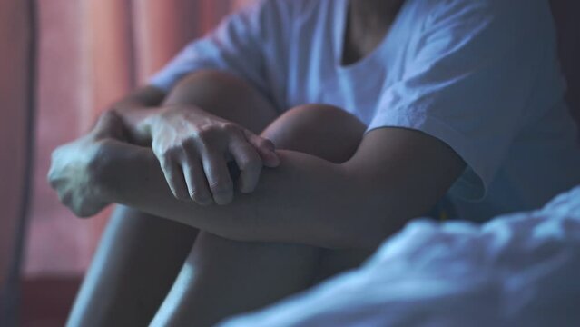 lonely woman in ,dark bedroom Fight Depression and Self,Harm,Emotional Stress Concept, mental and emotional health problems.