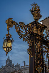 Fototapeta na wymiar Nancy, France - 09 02 2023: Unesco World Heritage. View a golden the gate in Stanislas Square at sunrise.