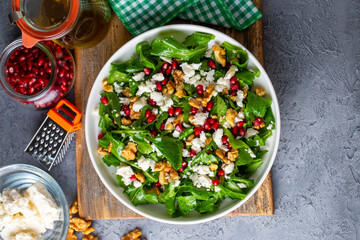 Arugula salad with cheese served with walnuts and pomegranate. Turkish name; Roka salatasi